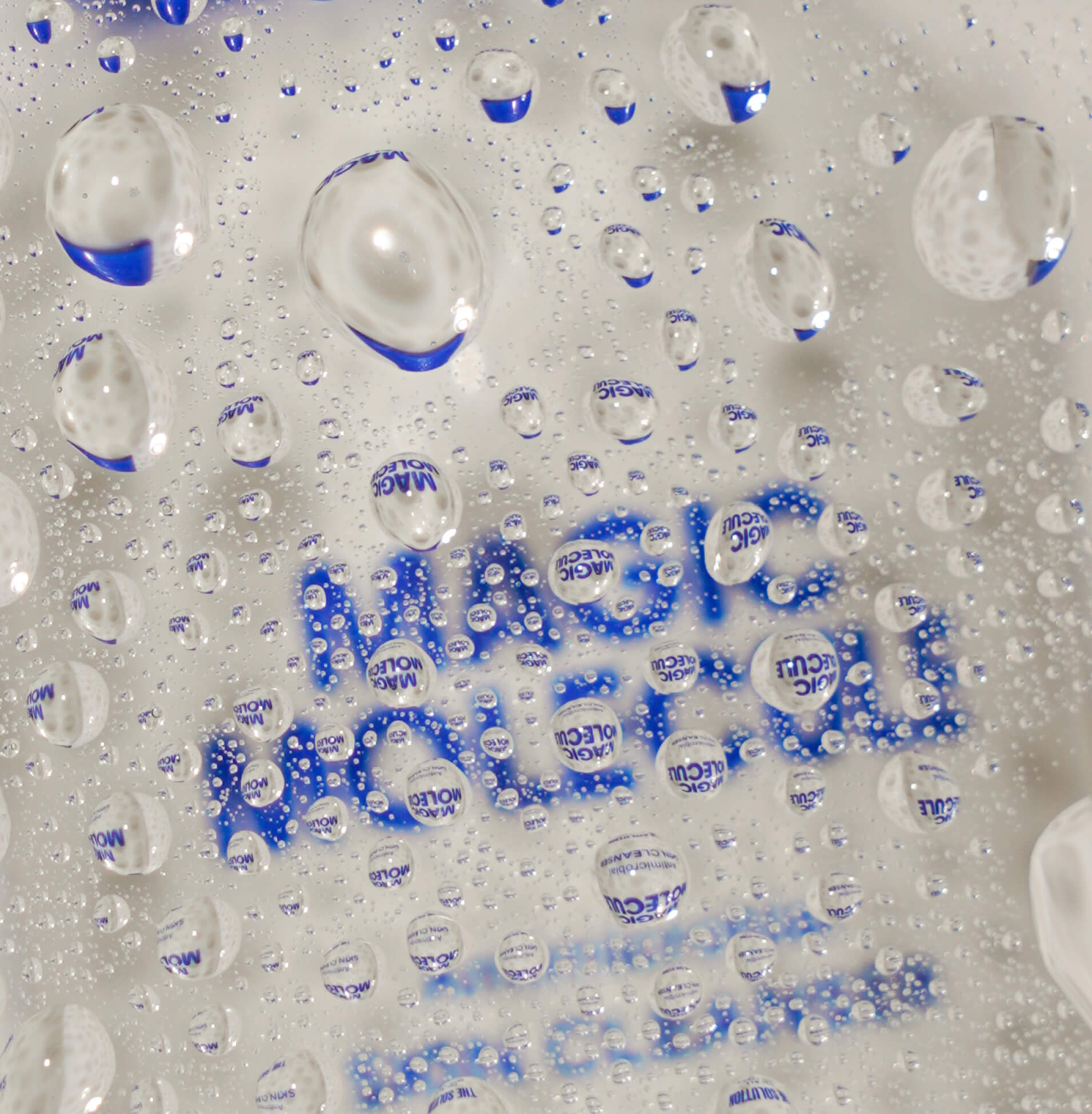 Bottle of Magic Molecule obscured by water droplets